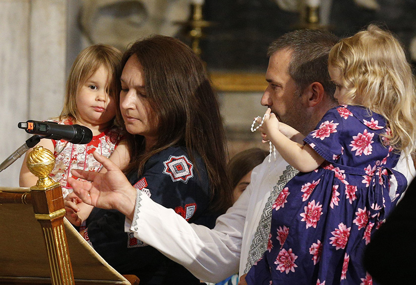 Family members from Ukraine led a decade of the Rosary during a prayer service with Pope Francis in front of the statue of Mary, Queen of Peace, at the Basilica of St. Mary Major in Rome May 31. The pope prayed for peace as he closed the Marian month of May.