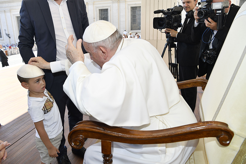 Pope Francis placed a zucchetto on the head of a little boy as he tried on a new one at the end of his general audience in St. Peter’s Square June 15.