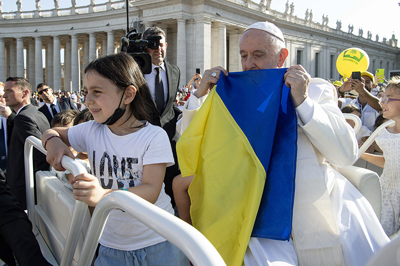 Pope Francis held a Ukrainian flag before Mass in St. Peter’s Square for the World Meeting of Families at the Vatican June 25.