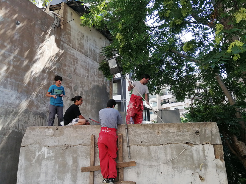 Caritas Lebanon Youth volunteers weatherproofed a leaky roof with sealant for a home in Beirut July 21 as part of the organization’s home renovation project. In all, 40 poor families all over Lebanon will be helped by the summer project to improve their living conditions.