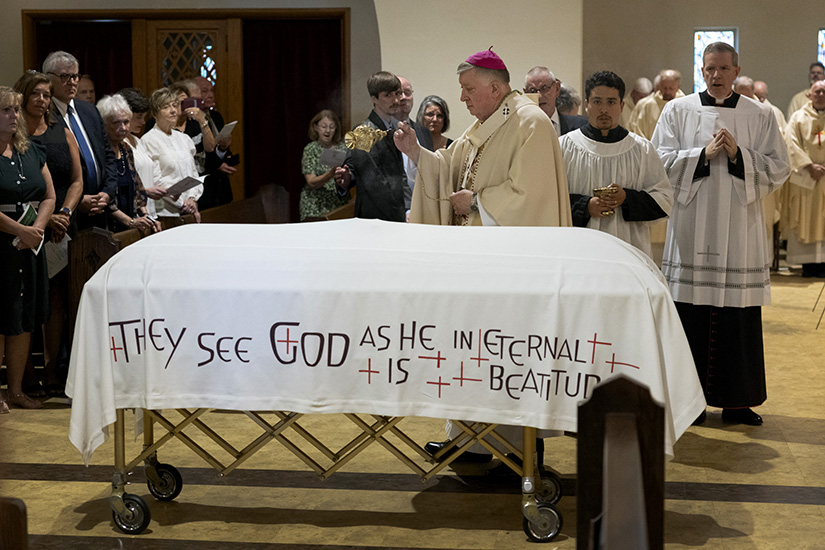Archbishop Mitchell T. Rozanski used incense around Bishop Morgan A. Casey’s casket during a funeral Mass on Aug. 6, at St. Mary Magdalen Church in Brentwood. Bishop Casey died July 27 at the age of 87.