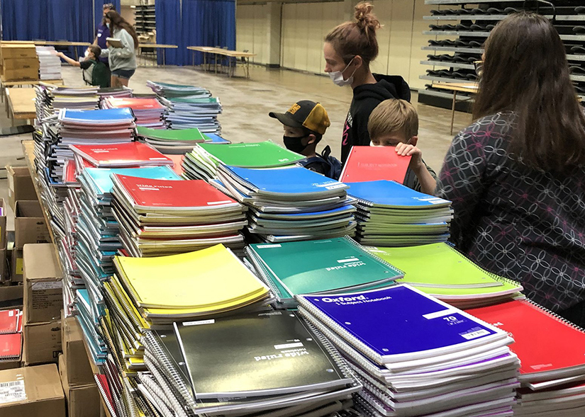 Participants looked through stacks of notebooks at a back-to-school drive sponsored by Catholic Charities of La Crosse, Wis., at the La Crosse Center Arena Aug. 9 and 10. Students were provided with free backpacks to fill with new donated supplies for the school year.