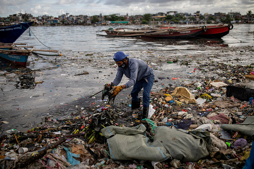 Argie Aguirre, a member of the River Warriors, gathered trash from the polluted Pasig River in Manila, Philippines, June 22, 2021.