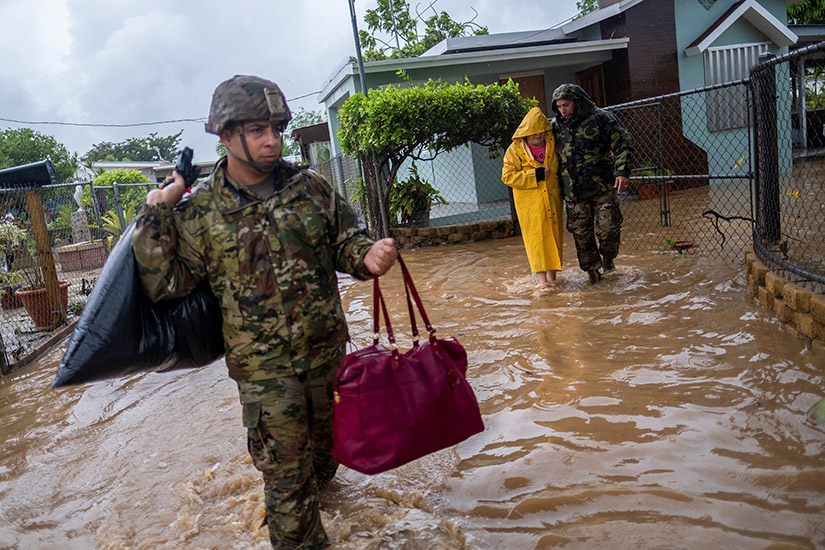 Members of the Puerto Rico National Guard rescued a woman stranded in her house Sept. 19 in the aftermath of Hurricane Fiona in Salinas, Puerto Rico.