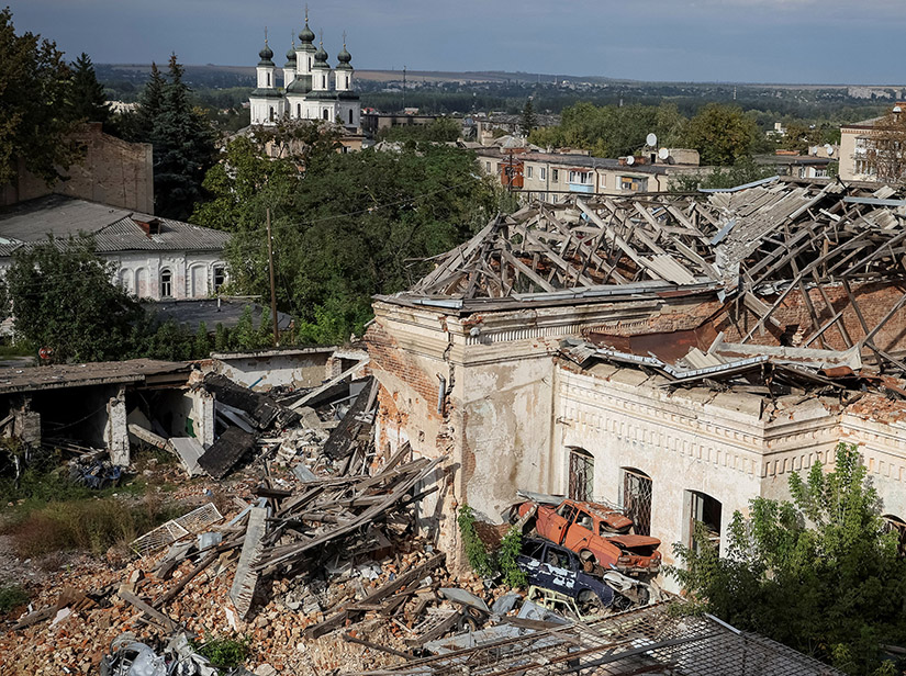 Destroyed houses and cars are seen in Izium, recently liberated by Ukrainian Armed Forces, in the Kharkiv region of Ukraine, Sept. 20. Cardinal Konrad Krajewski, the papal almoner, was in the area to pray at a mass grave found in the forest near Izium.