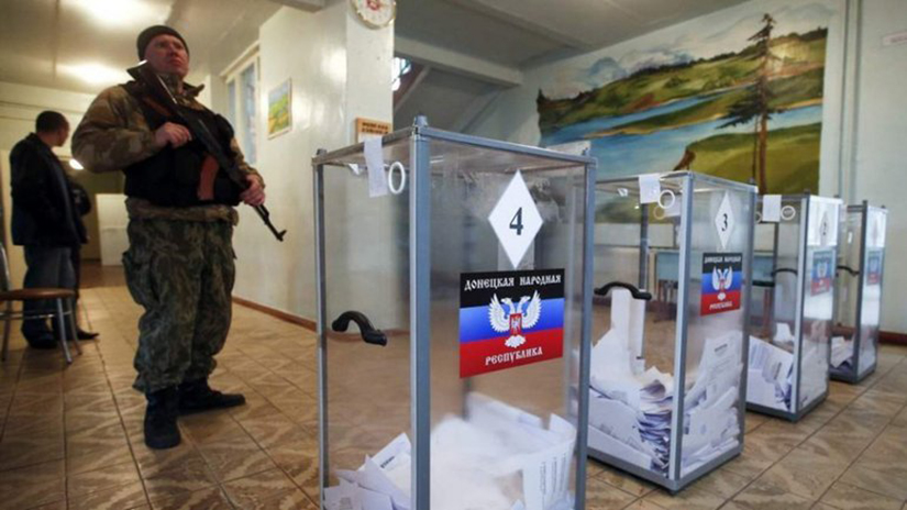 A Russian soldier stood guard at a polling station in Ukraine’s Donetsk region Sept. 23. The referendum was conducted against a background of Russian President Vladimir Putin warning of using all weapons at his disposal in the event of an attack on Russian territory.