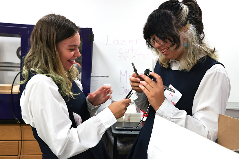 Incarnate Word Academy sophomore Erika Samuelson, left, and senior Audrey Hess worked on the robotics and STEM team robot Sept. 23 at the school in Bel-Nor. Student STEM Ambassadors prepared STEM kits for more than 450 elementary students at Catholic elementary schools.