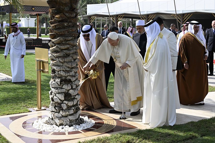 Pope Francis watered a palm tree before addressing the Bahrain Forum for Dialogue: East and West for Human Coexistence Nov. 4 in Awali, Bahrain. 