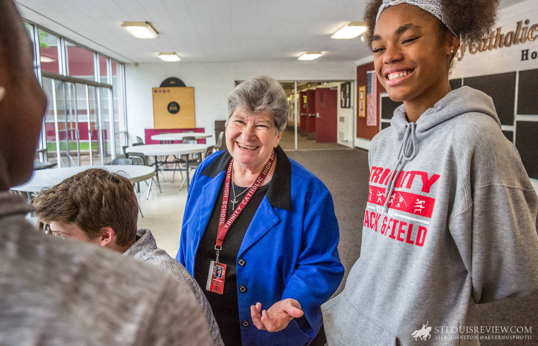 Sister Karl Mary Winkelmann, SSND, talked with students, including Kayla Millett, in the hallway of the school on May 21. She encouraged the teens who are headed to state track championships in Jefferson City at the end of the week. Sister Karl Mary is retiring as president of Trinity Catholic High School at the end of the 2017-18 school year.