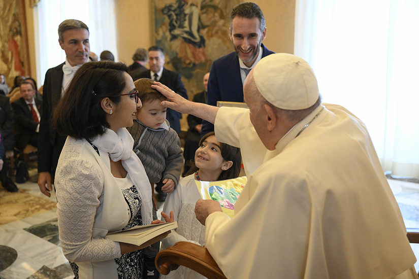 Pope Francis blessed a child during an audience with members of the World Union of Catholic Teachers at the Vatican Nov. 12.