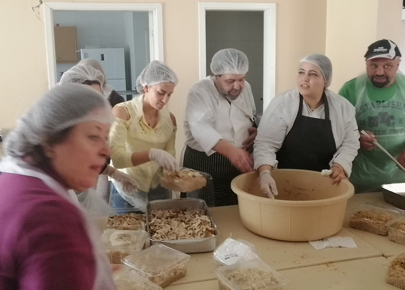 Volunteers prepared containers of hot meals to be delivered to 230 needy people in Zahle, Lebanon, Oct. 20. The initiative is a joint effort between the Jesuits of Lebanon and international businessman Nabil Chartouni, a Zahle native, known for his Lebanese company Faqra Catering.