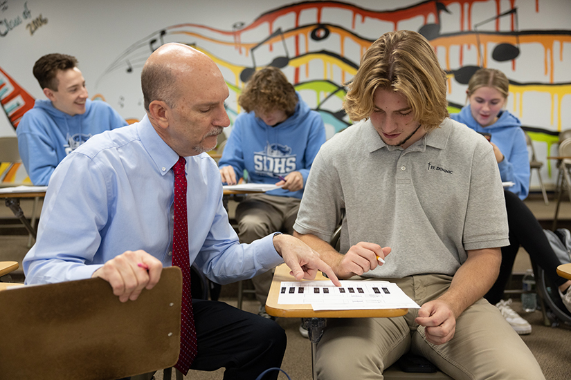 St. Dominic High School teacher Greg Cissell worked with senior Nash Kell during a music theory class Nov. 21 at St. Dominic High School in O’Fallon. Cissell, in his 27th year teaching at the high school, is a recipient of the Emerson Excellence in Teaching Award.