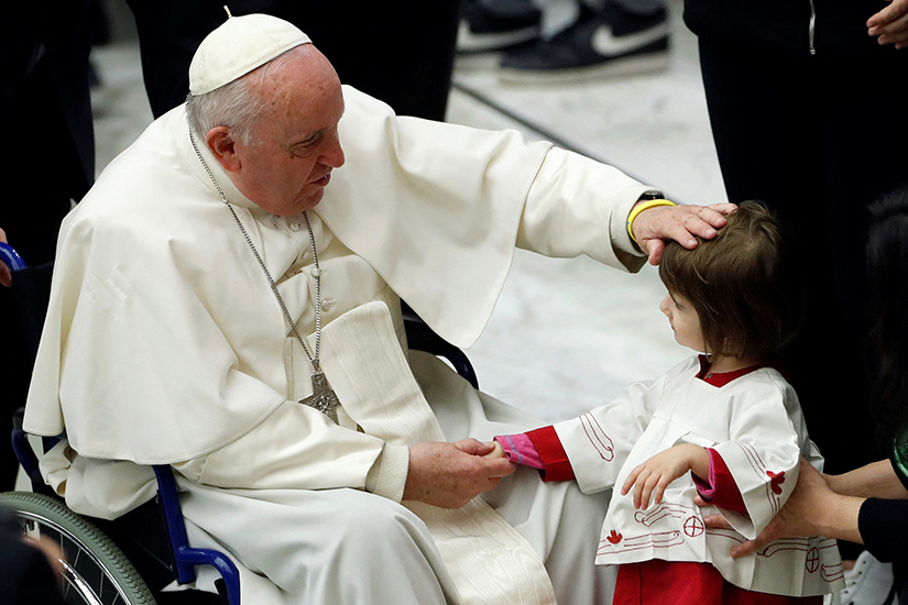 Pope Francis greeted a child during his weekly general audience at the Vatican Dec. 7.