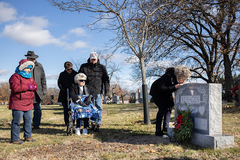 Gathered with family members, Carol O’Neil, standing at front center, and her mother Ottilia Rehagen, in wheelchair, prayed at the grave of Carol’s father, Thomas Rehagen, a Navy veteran of the Korean War, after a wreath was placed at the grave during a Wreaths Across America event Dec. 17 at Resurrection Cemetery in south St. Louis County. National Wreaths Across America Day features wreath-laying events at Arlington National Cemetery and more than 3,400 other sites, according to wreathsacrossamerica.org.
