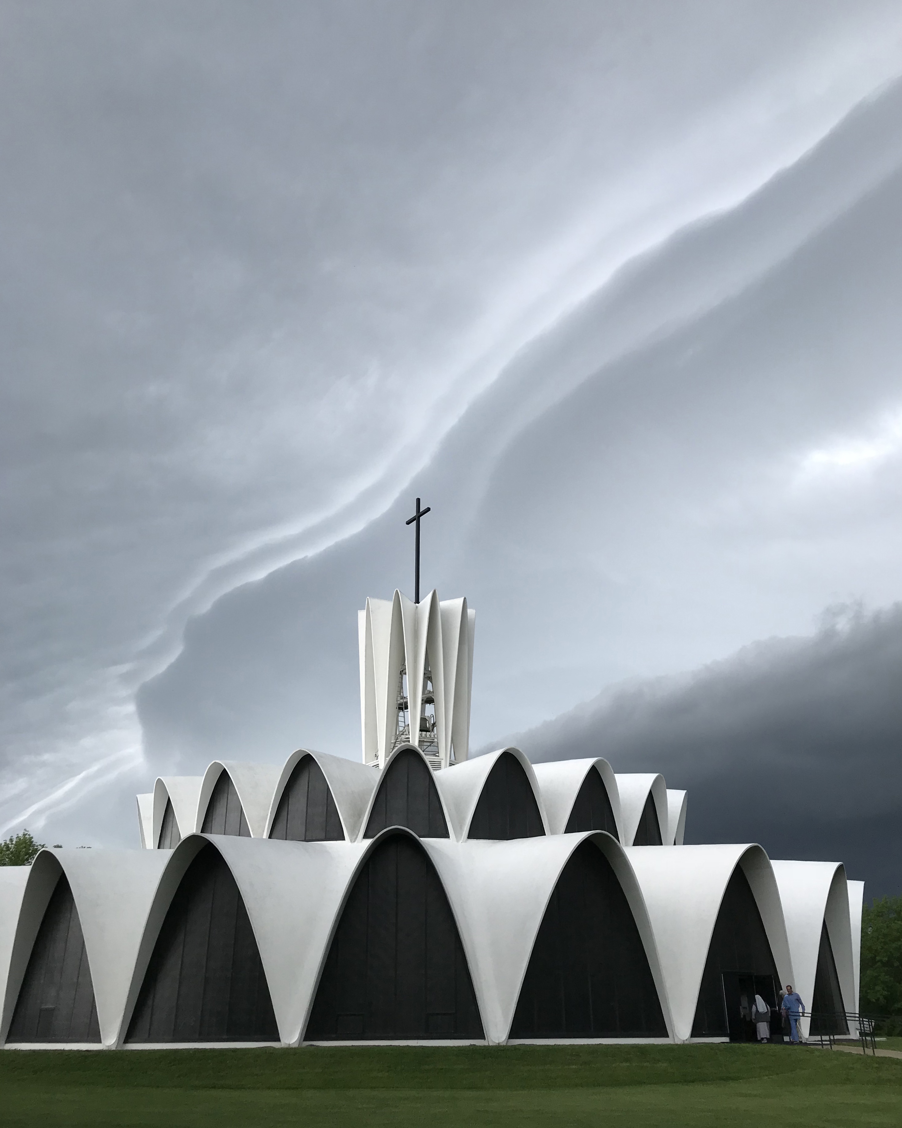 A shelf cloud approached from the west over the Church of Saint Mary and Saint Louis (Abbey Church) in Creve Coeur on May 22. The church’s circular facade consists of three tiers of whitewashed, thin-poured concrete parabolic arches, with the top one forming a bell tower. The church was designed by Gyo Obata of Hellmuth, Obata and Kassabaum (HOK) with consultation by Italian architect and engineer Pier Luigi Nerv. Construction was completed in 1962, and the church was dedicated and blessed that year.
