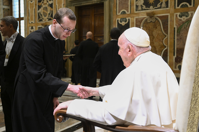 Pope Francis greeted a member of the Pontifical North American College during an audience with seminarians and staff of the college at the Vatican Jan. 14. The pope said dialogue, communion and mission are essential to priestly formation.