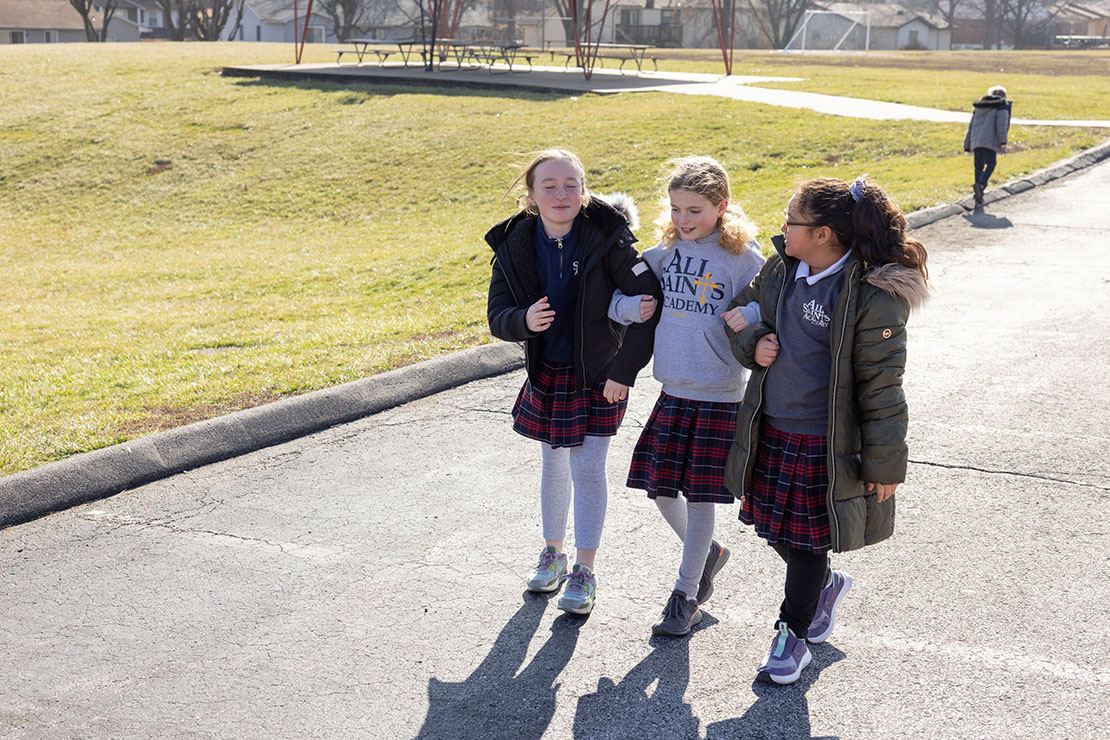 Fourth-graders, from left, Eloise Kammermeyer, Helen James and Priscilla Medina locked arms during recess Jan. 23 at All Saints Academy at St. Rose Philippine Duchesne in Florissant.