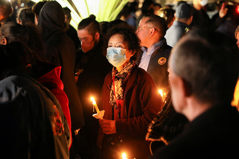 People gathered for a candlelit prayer vigil outside the entrance of the Star Ballroom Dance Studio in Monterey Park, Calif., Jan. 23. A mass shooting at the studio late Jan. 21, the eve of the Lunar New Year, left at least 11 people dead and nine others injured in a neighborhood where thousands had gathered for Lunar New Year festivities.