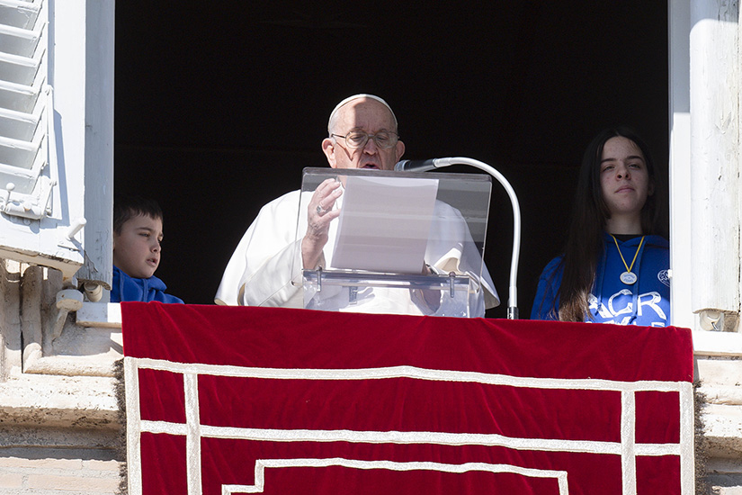 Pope Francis was accompanied by two children as he led the Angelus from the window of his studio overlooking St. Peter’s Square at the Vatican Jan. 29.