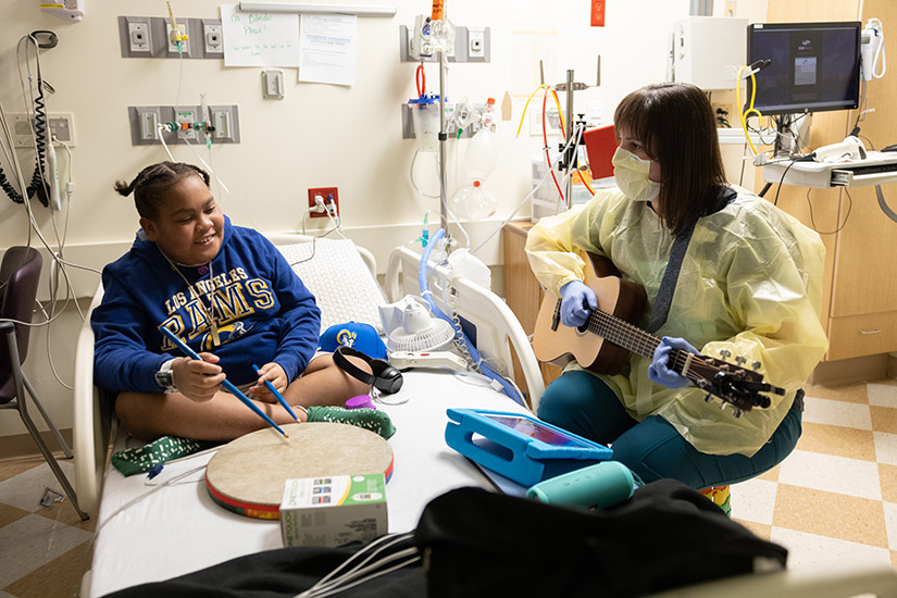 Tyler Hughes played a drum during a music therapy session with Carrie Lemen, a music therapist at SSM Health Cardinal Glennon Children’s Hospital, in November.