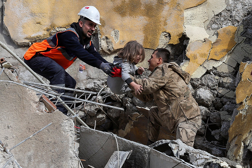 Muhammet Ruzgar, 5, was carried out by rescuers from the site of a destroyed building in Hatay, Turkey, Feb. 7. A powerful 7.8 magnitude earthquake rocked areas of Turkey and Syria early Feb. 6, toppling hundreds of buildings and killing thousands.