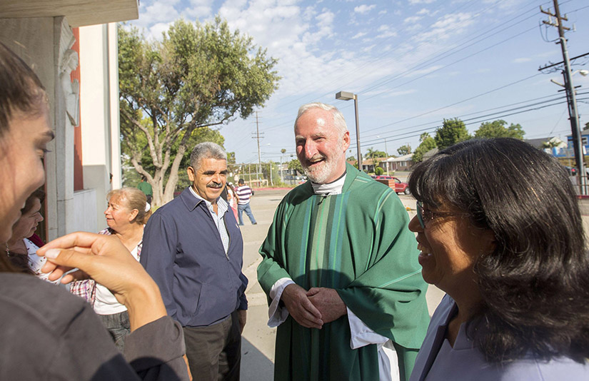 Los Angeles Auxiliary Bishop David G. O’Connell is pictured speaking with parishioners outside St. Frances X. Cabrini Church in Los Angeles July 19, 2015. Bishop O’Connell was killed Feb. 18 at his home. A native of Ireland, he spent most of his four decades as a priest ministering in Los Angeles. He was 69.