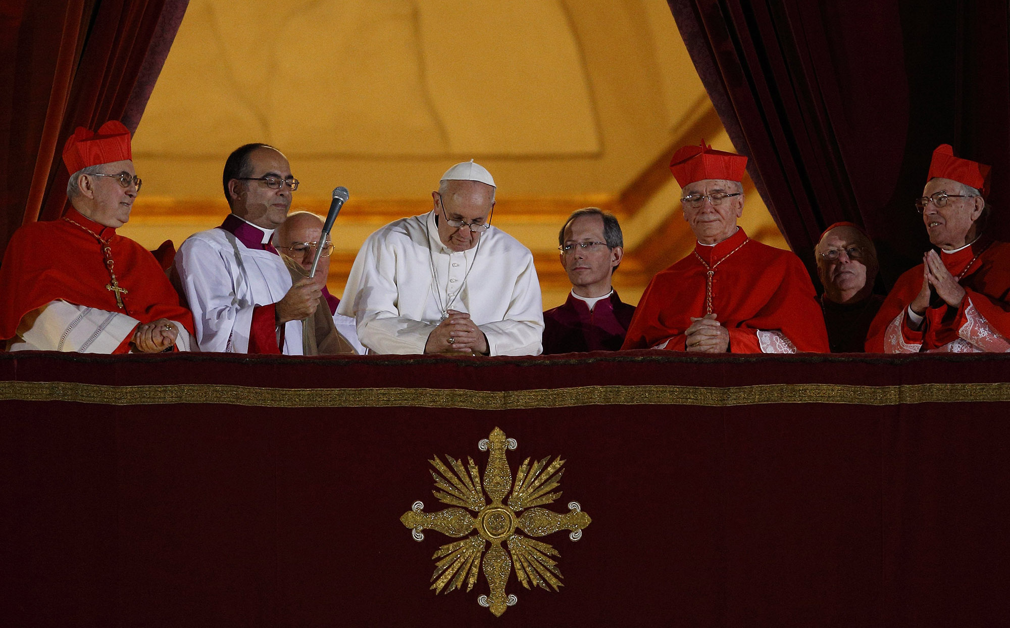 Pope Francis bowed his head in prayer during his election night appearance on the central balcony of St. Peter’s Basilica at the Vatican March 13, 2013. The crowd joined the pope in silent prayer after he asked them to pray that God would bless him.