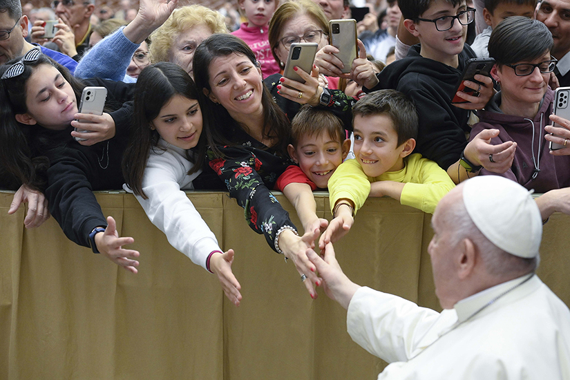 Pope Francis greeted parishioners from Rho in the Archdiocese of Milan during a meeting at the Vatican audience hall March 25.