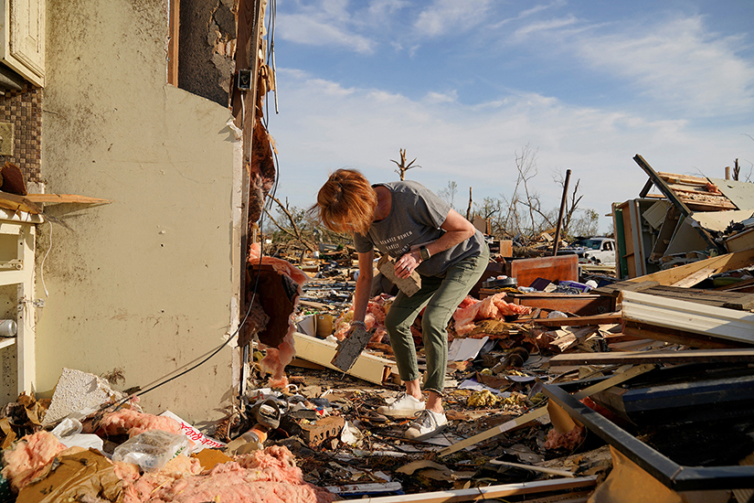 A woman looked through the debris of her friend’s home in Rolling Fork, Miss., March 27 after a tornado swept through.
