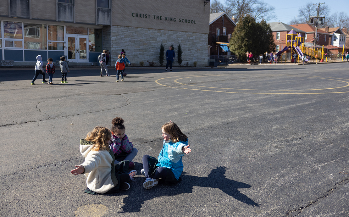 Second-grader Isabel Reinberg, right, played during recess with Daisy Wiseman, left, and Aubree Soucy on Feb. 24 at Christ the King School in University City.
