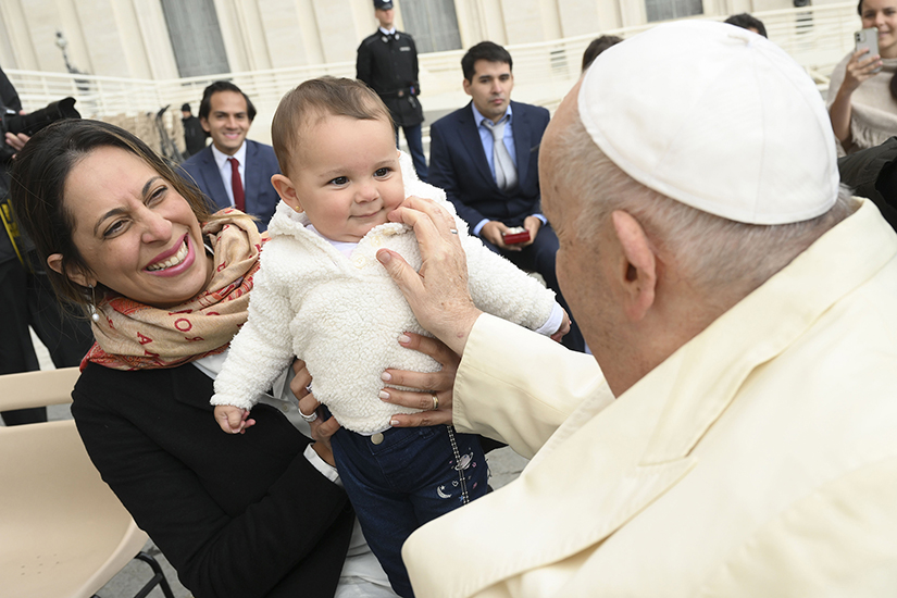 Pope Francis greeted a child in St. Peter’s Square at the Vatican after his weekly general audience April 5.