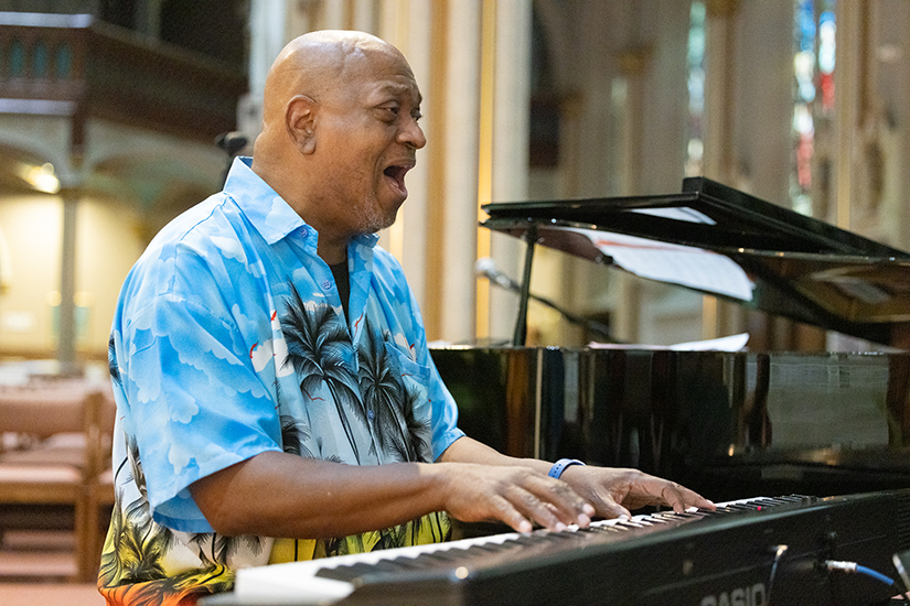 Simeon Layne Jr., director of the North City Deanery Choir, played piano during choir practice April 15 at St. Alphonsus Liguori “Rock” Church in St. Louis. Layne, a recipient of the Father Ed Feuerbacher Lifetime Achievement Award from the St. Charles Lwanga Center, said that when he plays music in church, nothing comes between him and God. “You’re in the presence of God, and you’re giving Him your total worship.”