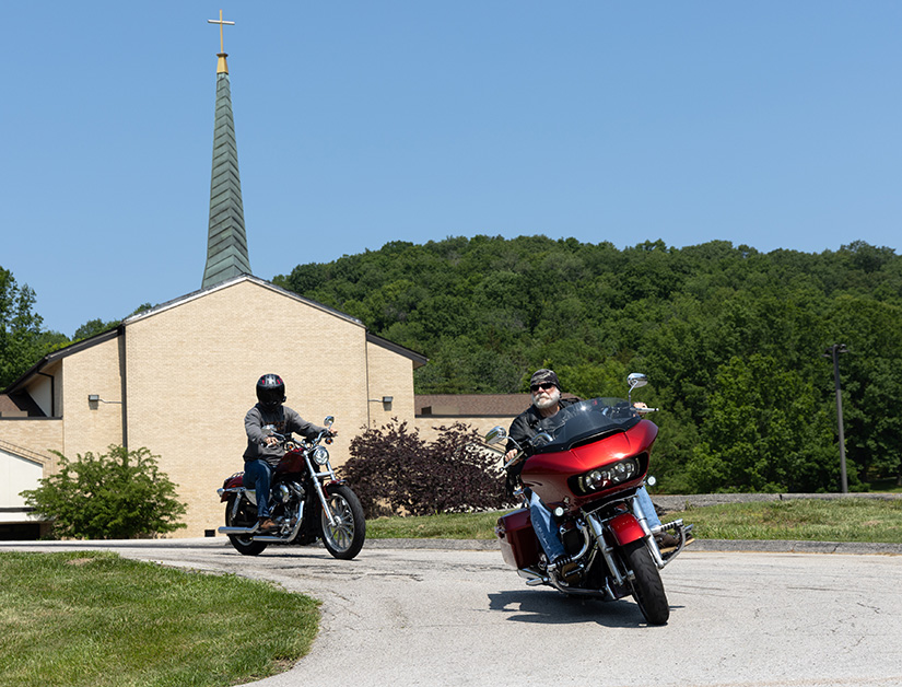 Mike Schalk, right, of Good Shepherd Parish and Daniel Bauer rode their motorcycles May 20 at Our Lady Queen of Peace Church in House Springs. The two were part of a group of riders on the Rosary Ride, in which they traveled to five churches and prayed a decade of the Rosary at each stop.