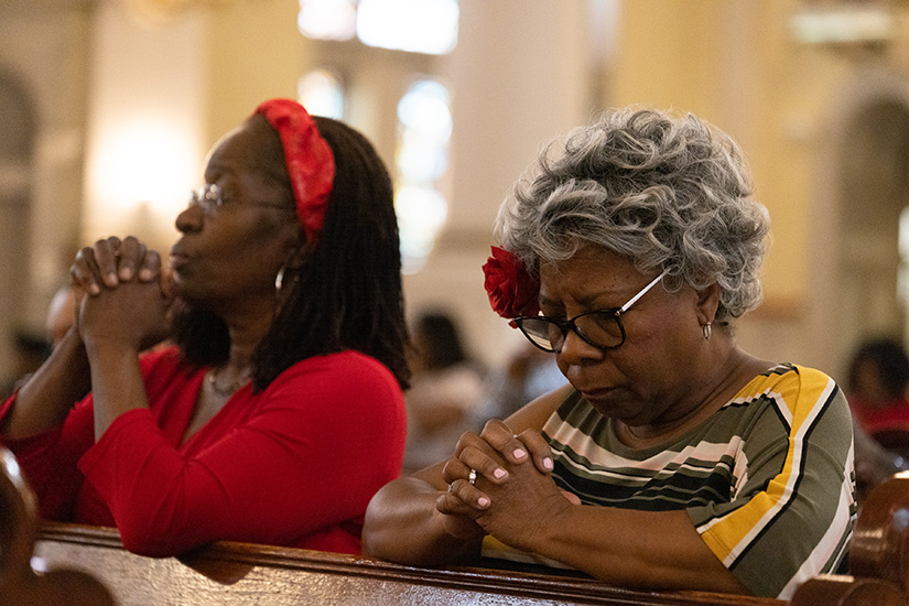 Valerie Dowdy, right, and Linda Mooney Nash prayed during Mass on Pentecost Sunday May 28 at Sts. Teresa and Bridget Church in St. Louis. "We get new hands, new brothers and sisters, new people to serve," Dowdy, a  Sts. Teresa and Bridget parishioner for about 25 years, said regarding the All Things New pastoral planning initiative. "I consider it a win all around."