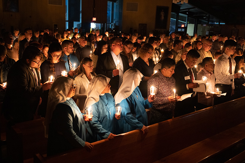 Churchgoers held candles during the Easter Vigil on April 8 at
Holy Rosary Parish in Warrenton. Twenty-four people entered
the Church from the parish at the Easter Vigil.