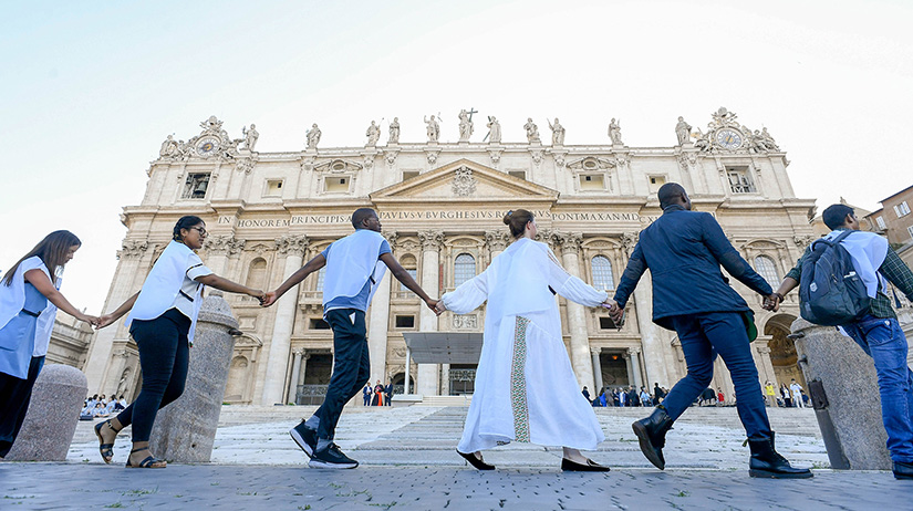 Young people joined hands and embraced in St. Peter’s Square at the Vatican after the signing of the Declaration on Human Fraternity during the World Meeting on Human Fraternity June 10.