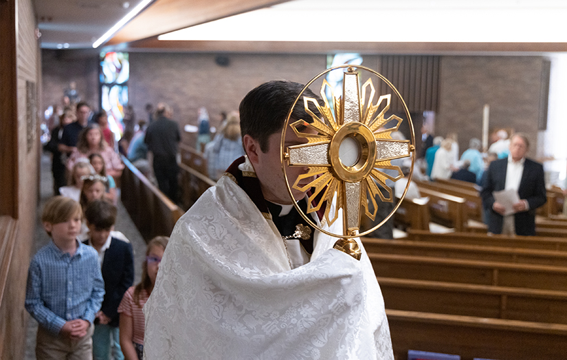 Father Michael Grosch carried the Blessed Sacrament through the church during a Corpus Christi procession June 11 at St. Gerard Majella in Kirkwood.