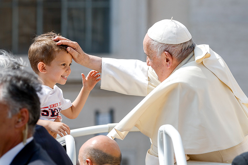 Pope Francis greeted a child as he rode in the popemobile leaving St. Peter’s Square at the Vatican after his weekly general audience June 28. His audience was his first since his surgery in June.