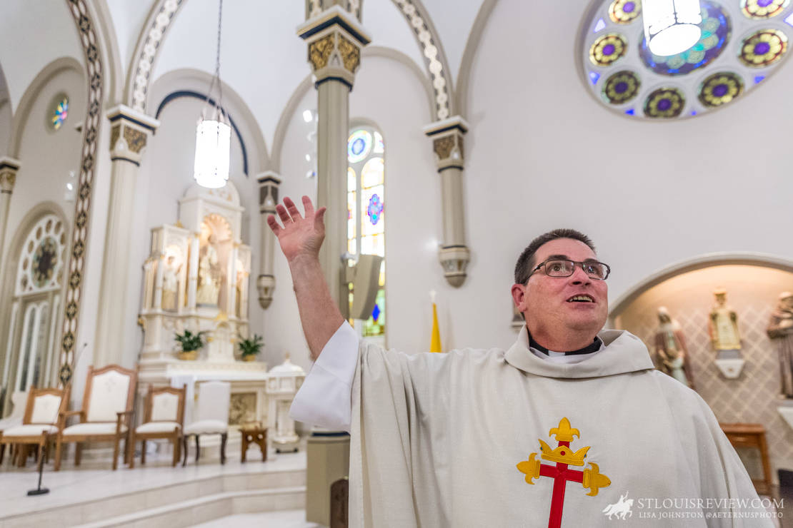 Father Gerald Blessing, pastor of St. Paul Parish in St. Paul, showed off the renovations of the church to visitors. The three-month project included painting, flooring, renovation of pews and more.
