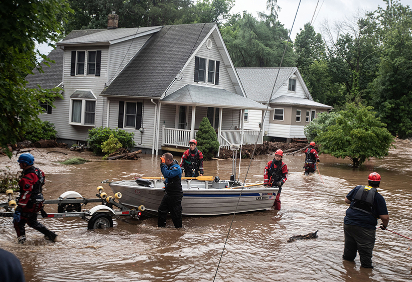 Emergency personnel maneuvered a boat used to rescue residents of flooded homes in Stony Point, N.Y., July 9. Severe storms left at least one dead in Orange County and dumped heavy rainfall at intense rates over parts of the Northeast.