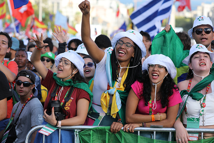 Pilgrims cheered prior to the opening Mass for World Youth Day at Eduardo VII Park in Lisbon, Portugal, Aug. 1. More than 350,000 pilgrims registered for the six-day event.