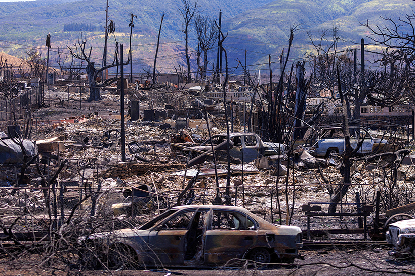 The shells of burned cars are pictured amid the ruins of homes in the ravaged town of Lahaina on the island of Maui Aug. 15.