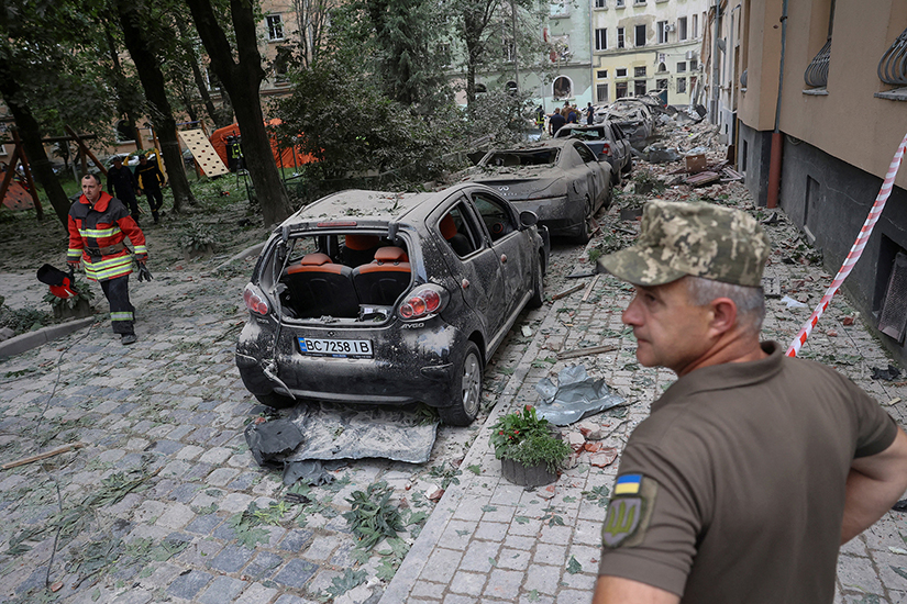 Emergency personnel examined the area around a residential building that was hit by a Russian missile strike in Lviv, Ukraine, July 6. The missile attack killed at least four people, injured 37 others and destroyed hundreds of homes, apartments and other buildings.