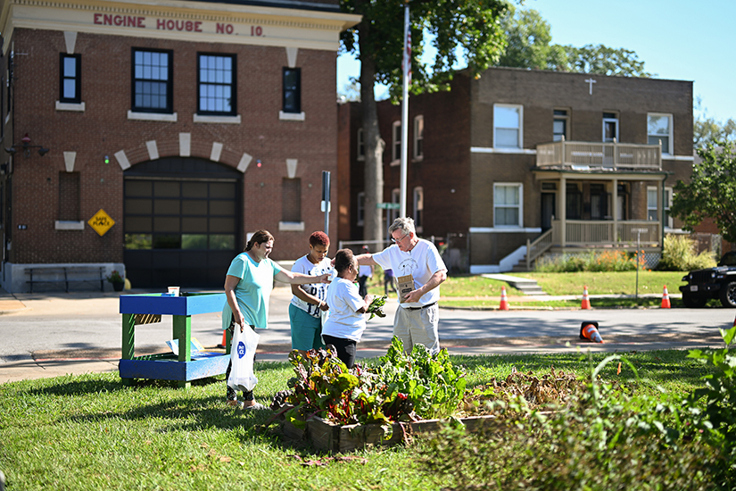 Steve Hutchison helped people sort through vegetables during a food and supplies distribution outside Claver House on Sept. 2 in the Ville neighborhood of north St. Louis.
