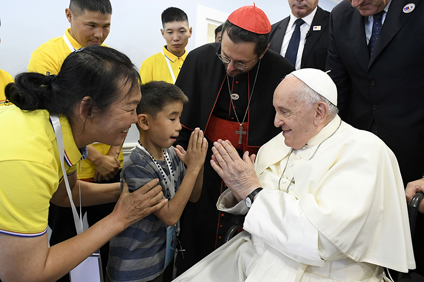 Pope Francis greets a child as he arrives at the inauguration of the House of Mercy in Ulaanbaatar, Mongolia, the final event of his four-day trip to Mongolia before returning to Rome Sept. 4.