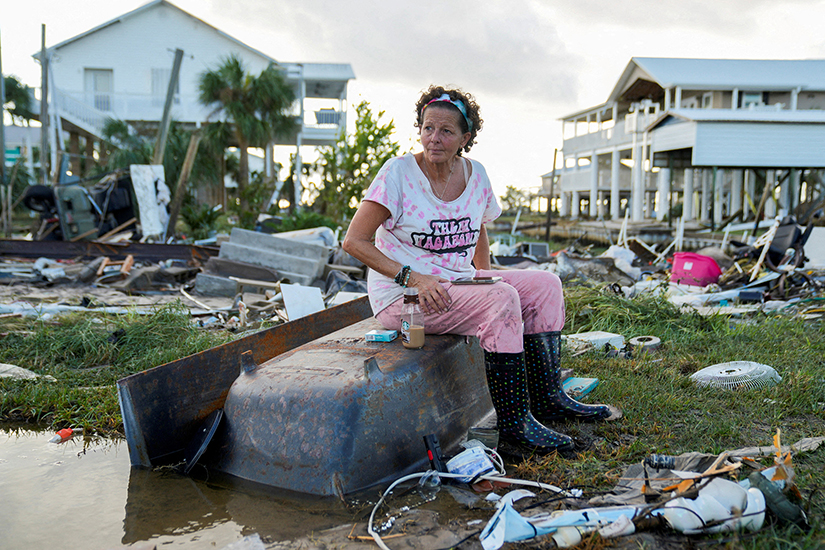 Jewell Baggett, 51, sat on a bathtub in Horseshoe Beach, Fla., Aug. 30 amid the wreckage of the home her grandfather built, where she grew up and three generations of her family have lived. The house was reduced to rubble by Hurricane Idalia, which made landfall in Florida’s Big Bend region early Aug. 30 as a Category 3 hurricane.