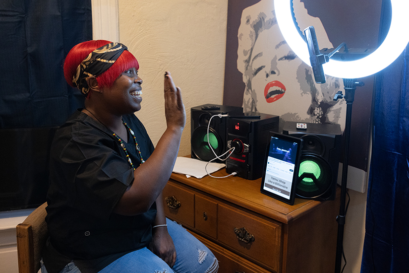 Javondra Harris waved during a livestream video at her home Sept. 20 in St. Louis. Harris recently graduated from the Pathways to Progress, a collaborative effort of Catholic Charities of St. Louis and St. Francis Community Services.