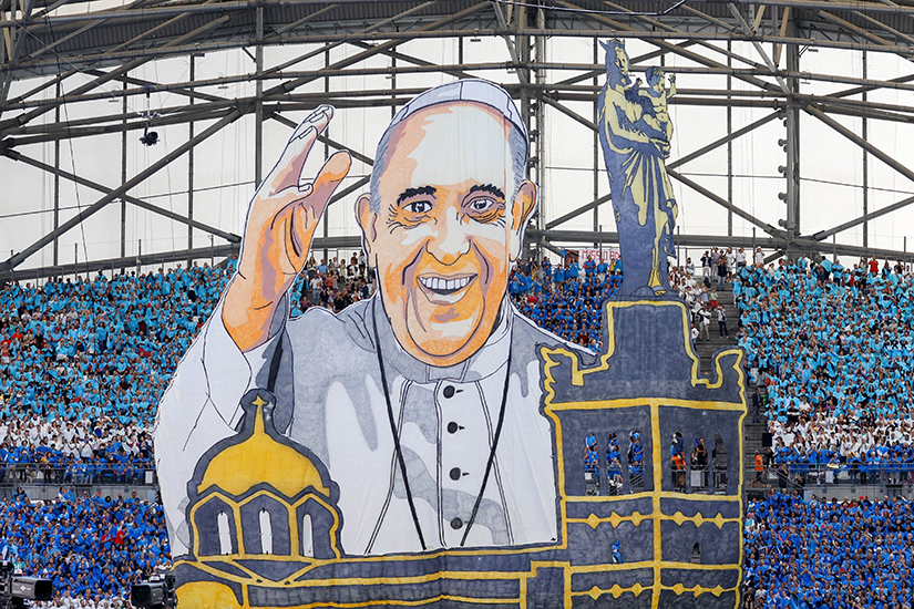 People displayed a “tifo,” a veil with Pope Francis’ image, before the pope celebrated Mass at the Vélodrome Stadium in Marseille, France, Sept. 23.