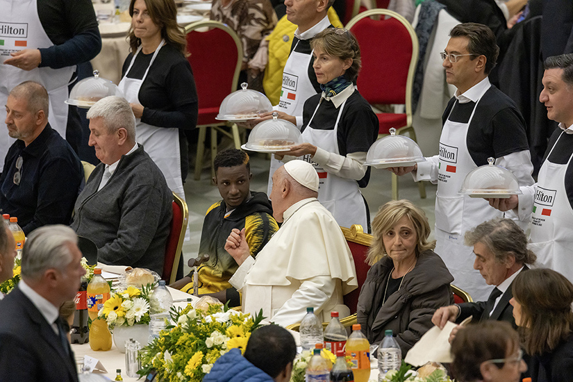 Pope Francis talked with one of his guests during a special luncheon in the Vatican audience hall Nov. 19, the World Day of the Poor.