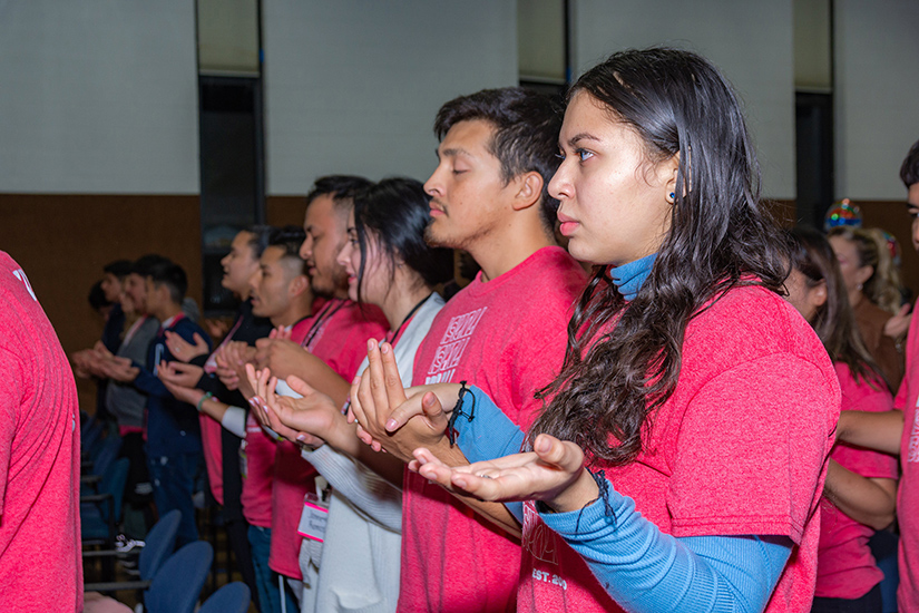 Young people affiliated with the Iskali organization prayed during Mass. For more than a decade, Iskali has been supporting young Latinos in their faith formation.